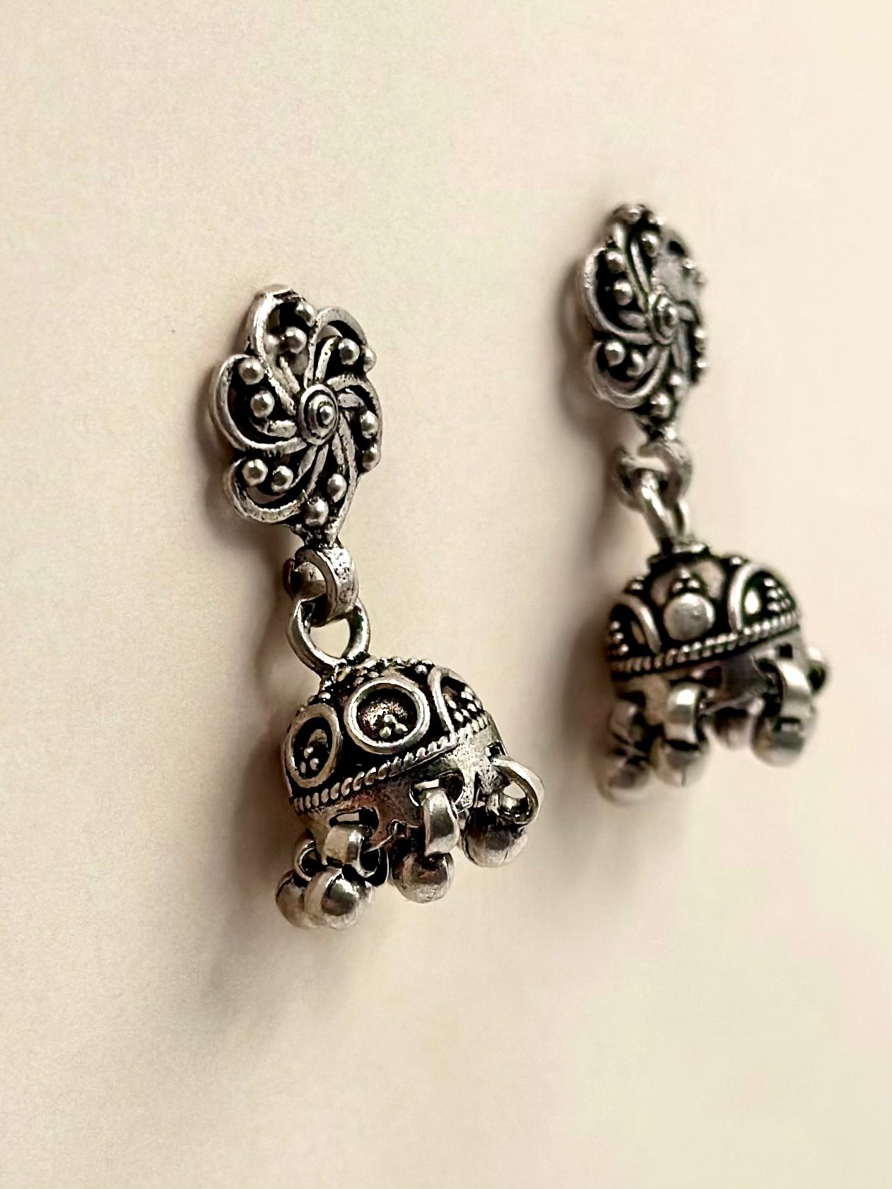 Oxidised, swirl flower shaped sterling silver jhumkas with fine details
