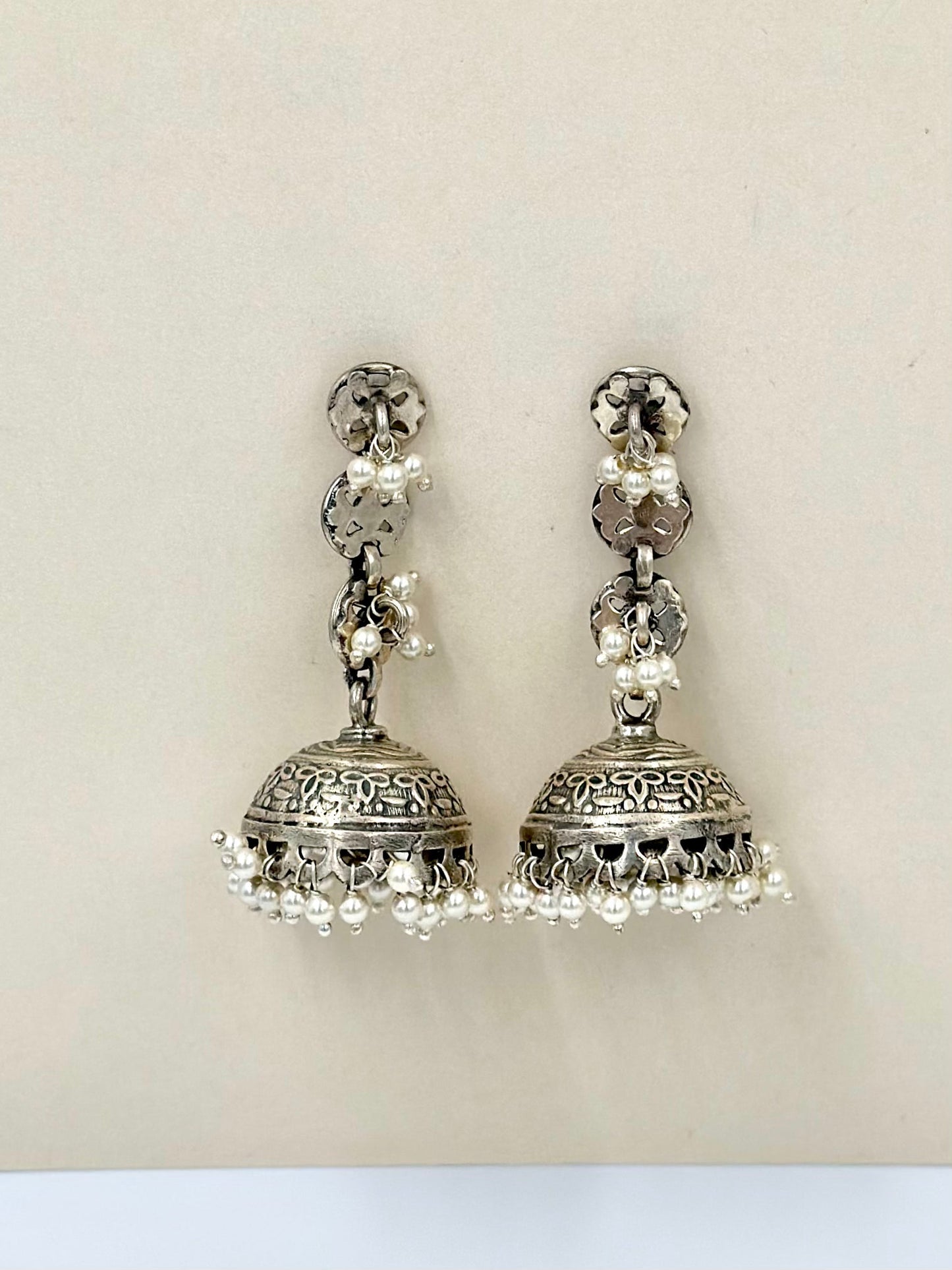 adorned with pearls, oxidised sterling silver jhumkas with fine detailing