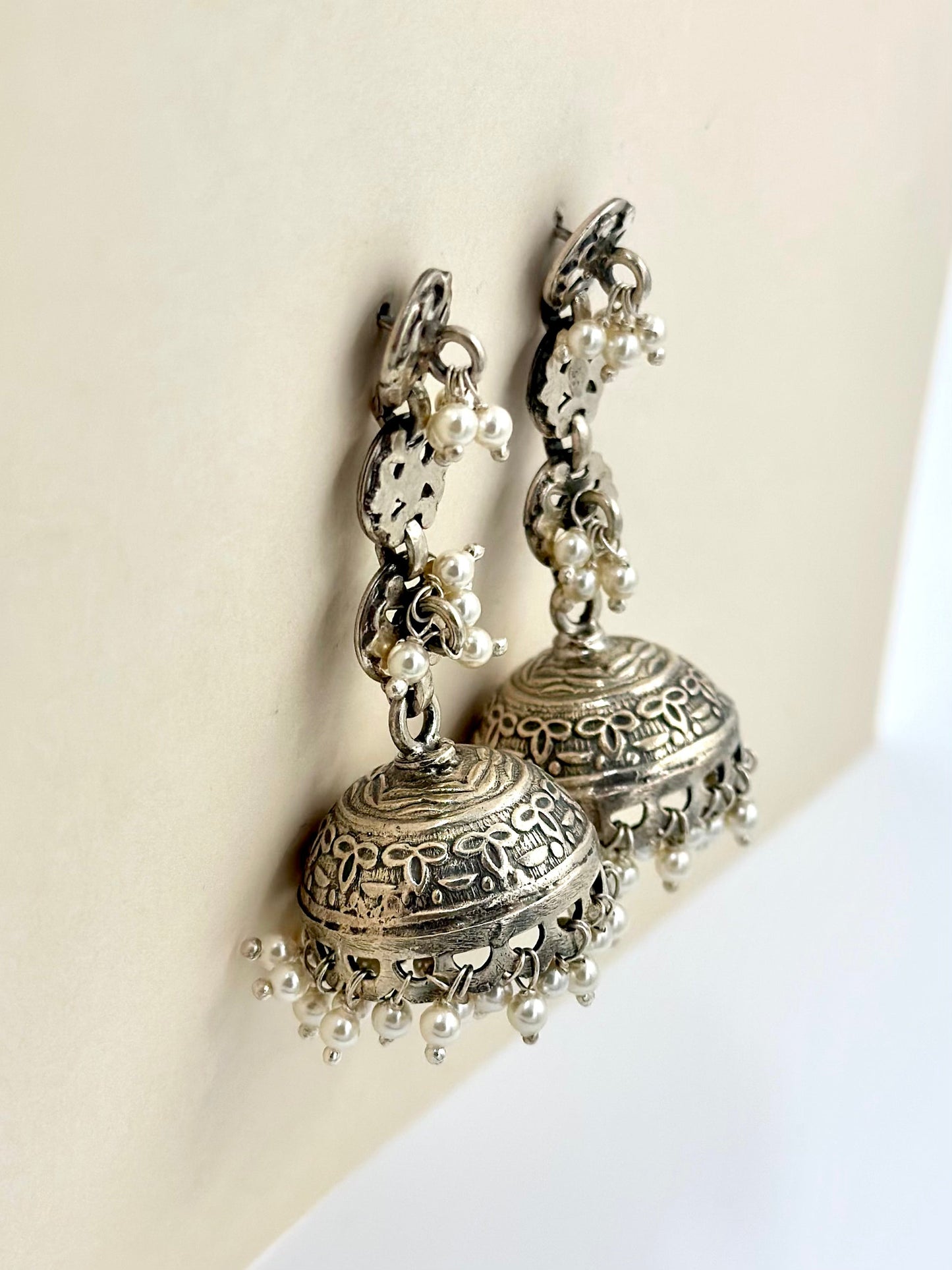 adorned with pearls, oxidised sterling silver jhumkas with fine detailing