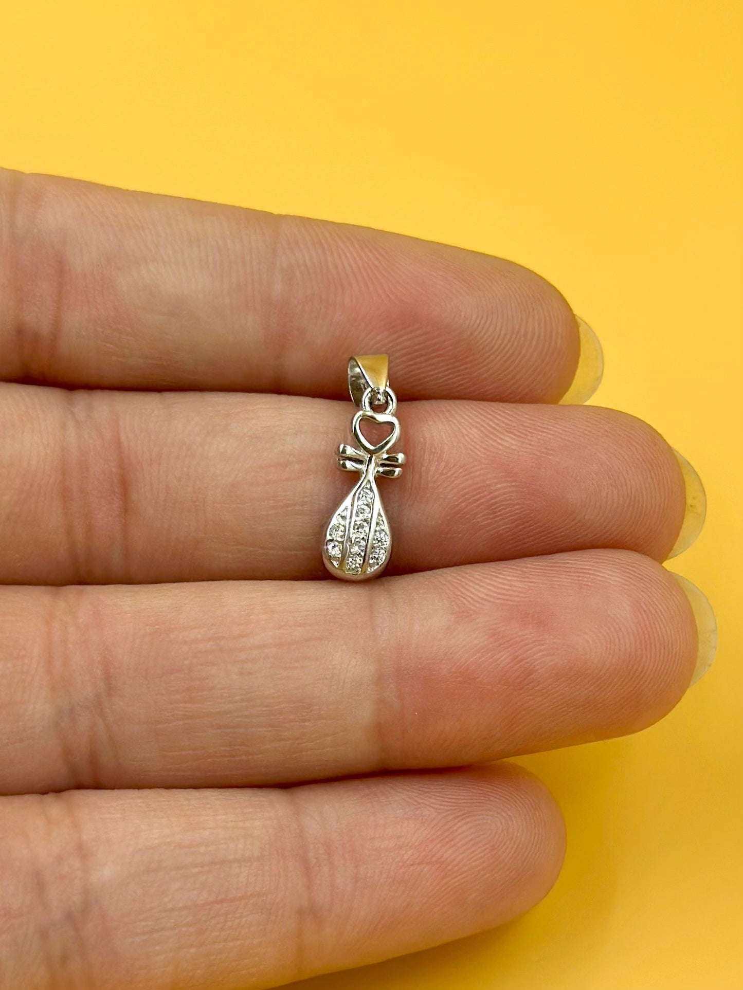 Zircon studded, key shaped sterling silver pendant