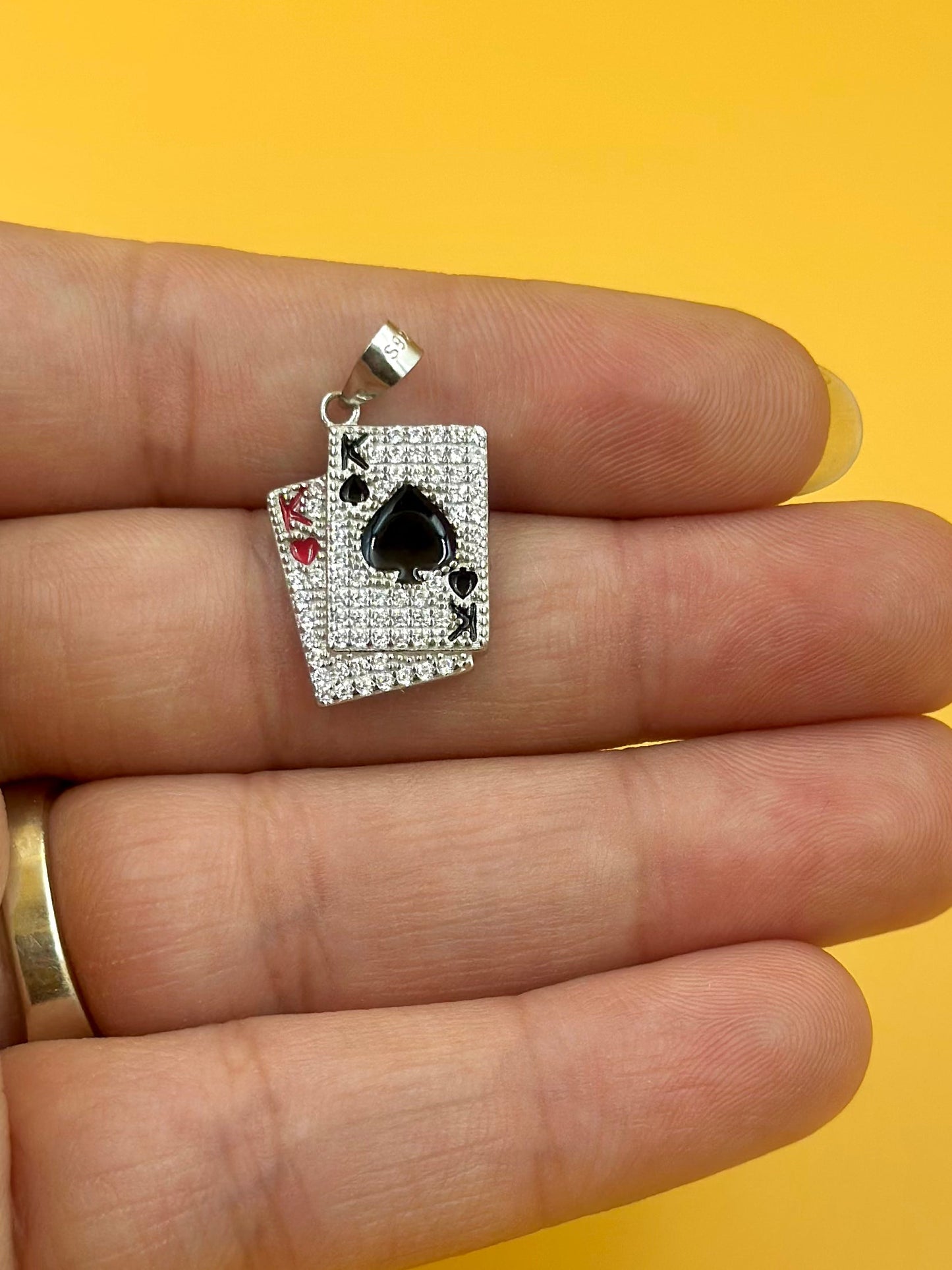 Zircon studded, enamel coated, card shaped sterling silver pendant