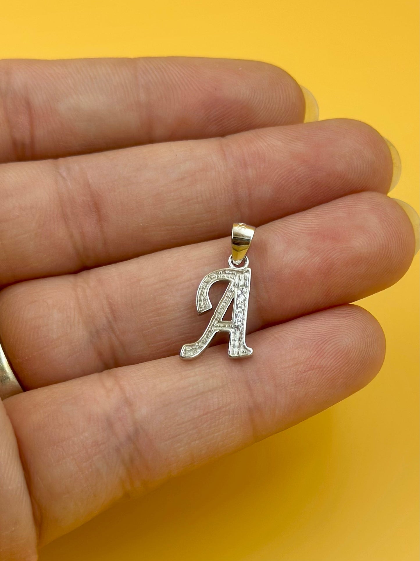 A shaped, zircon studded sterling silver pendant