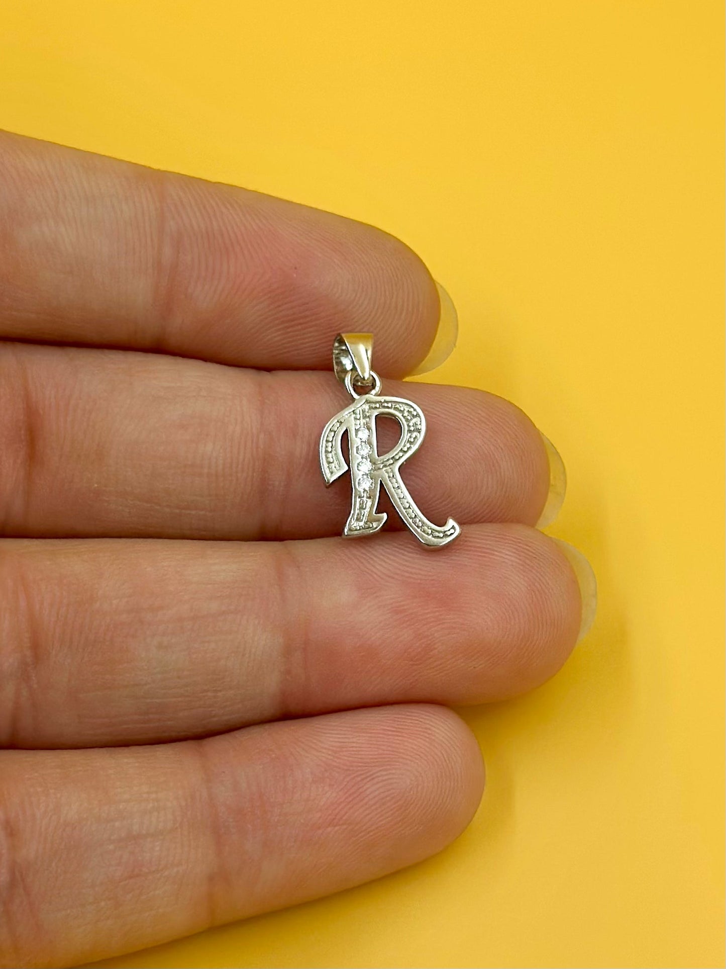 R shaped, zircon studded sterling silver pendant