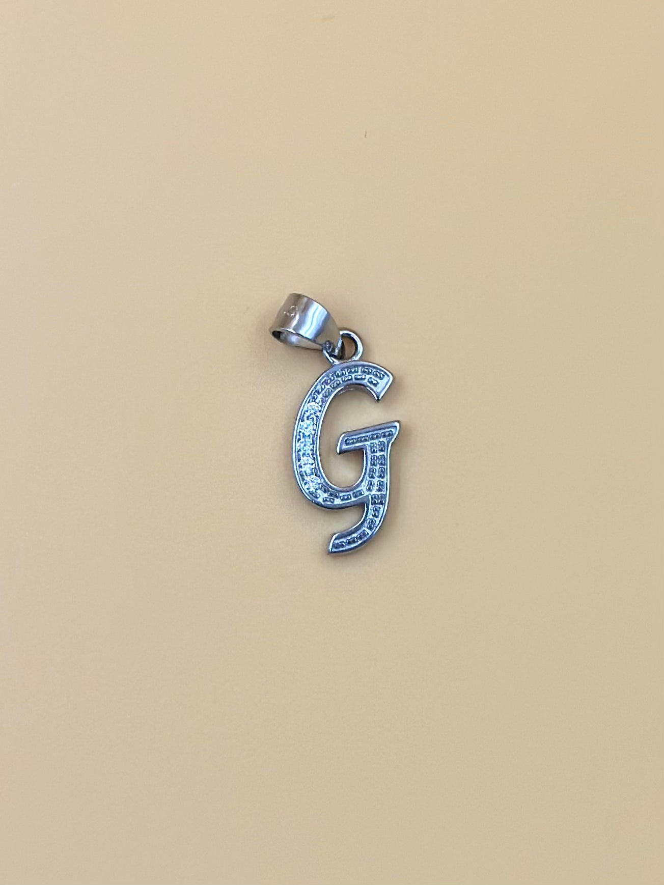 G shaped, zircon studded sterling silver pendant