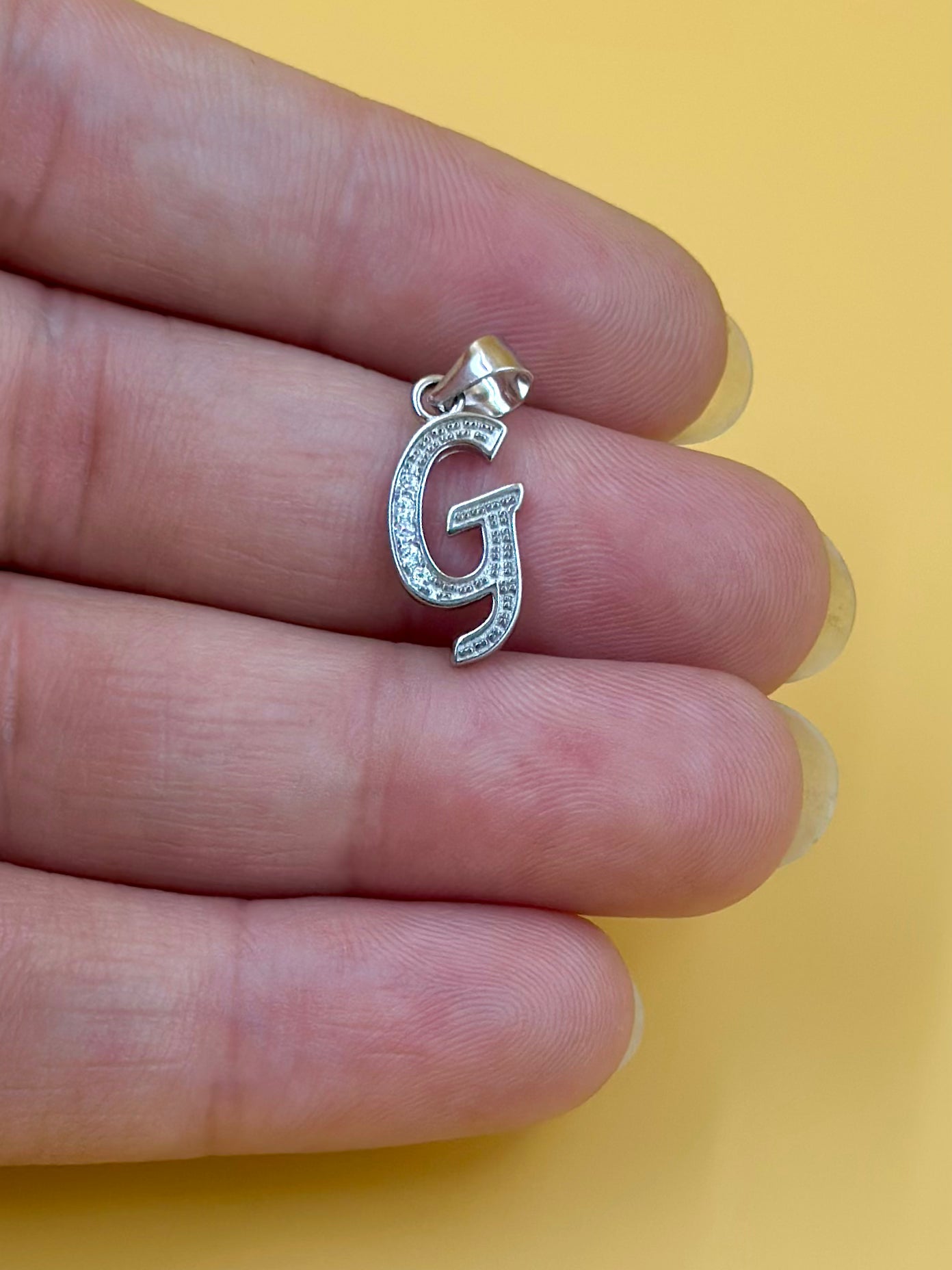 G shaped, zircon studded sterling silver pendant