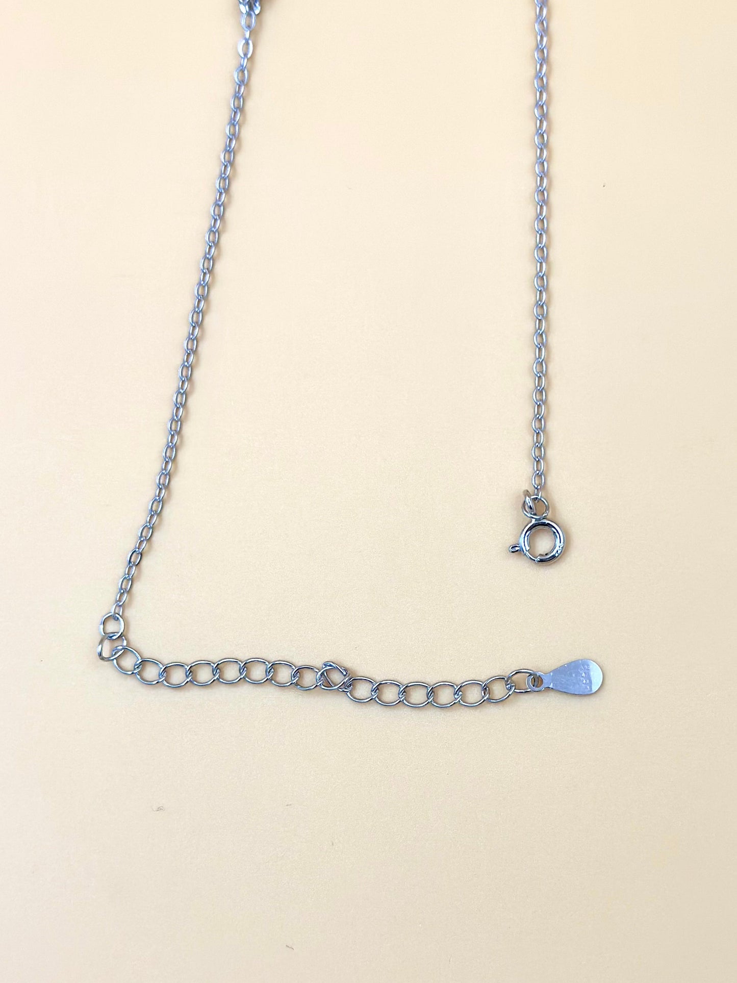 Zircon studded, flower shaped sterling silver pendant chain
