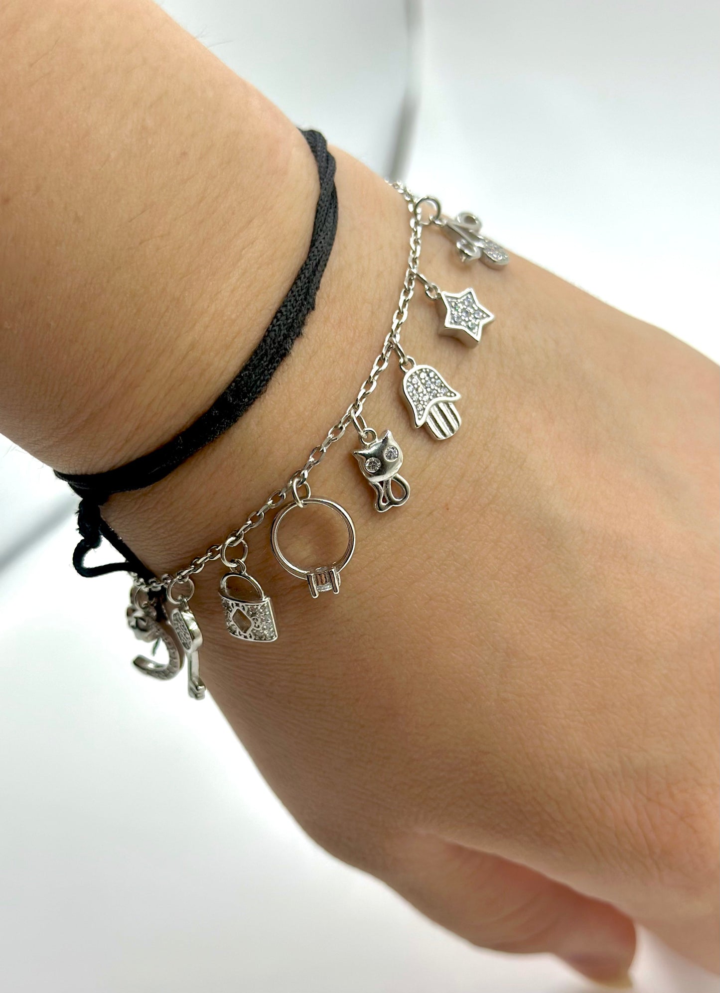 Zircon studded, many shapes charms studded sterling silver charm bracelet