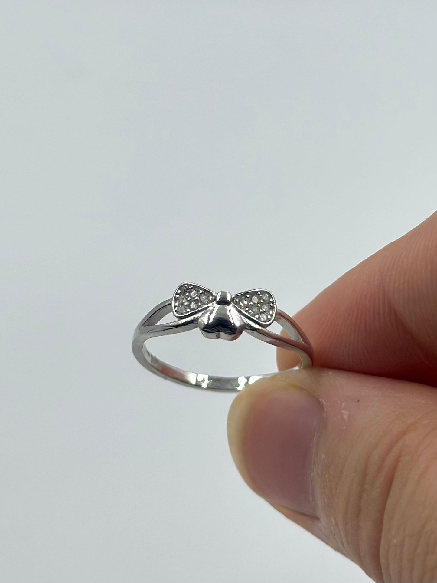 Zircon studded, bow shaped sterling silver artisanal ring
