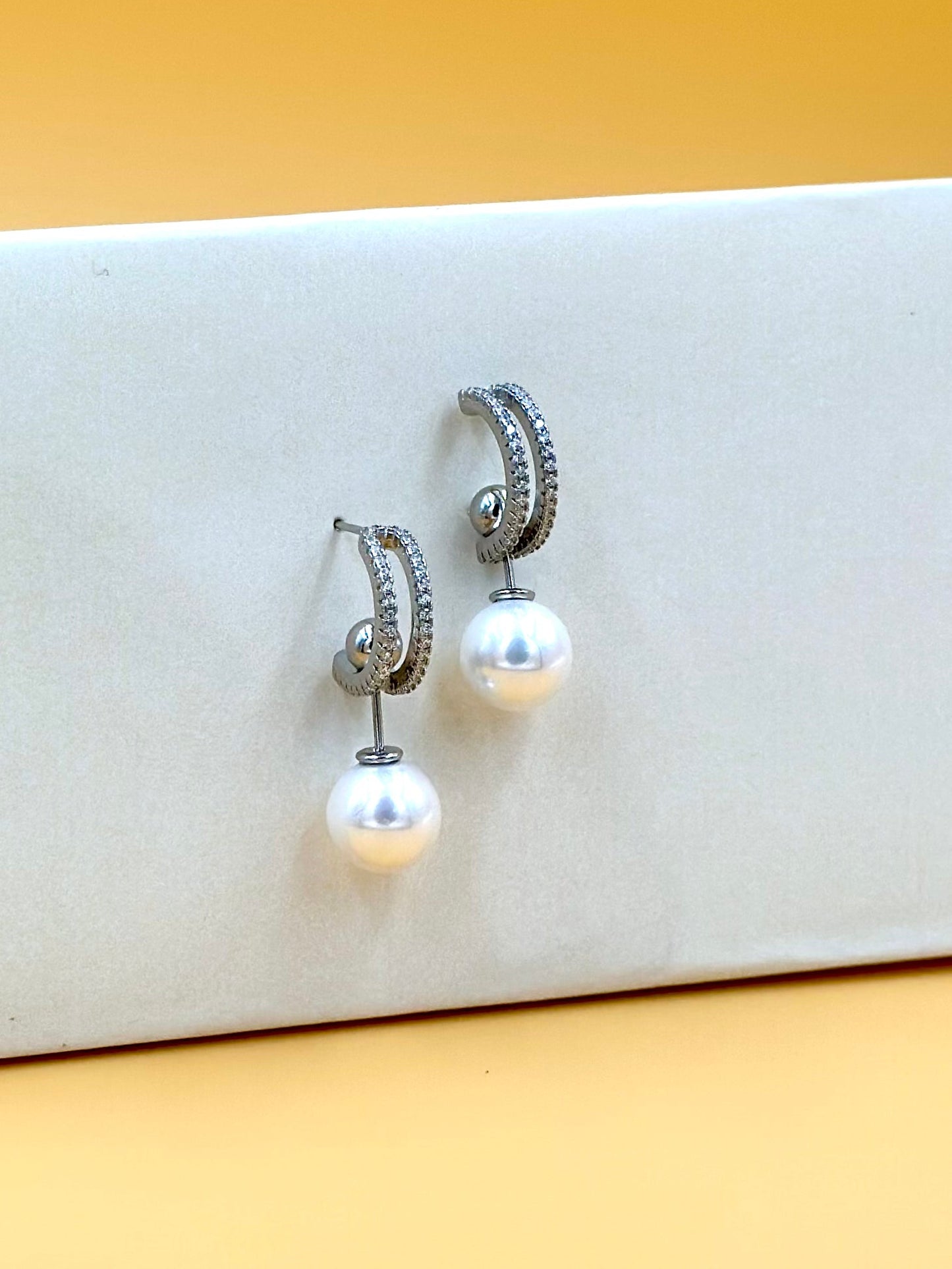 Zircon studded, pearl hanging sterling silver studs