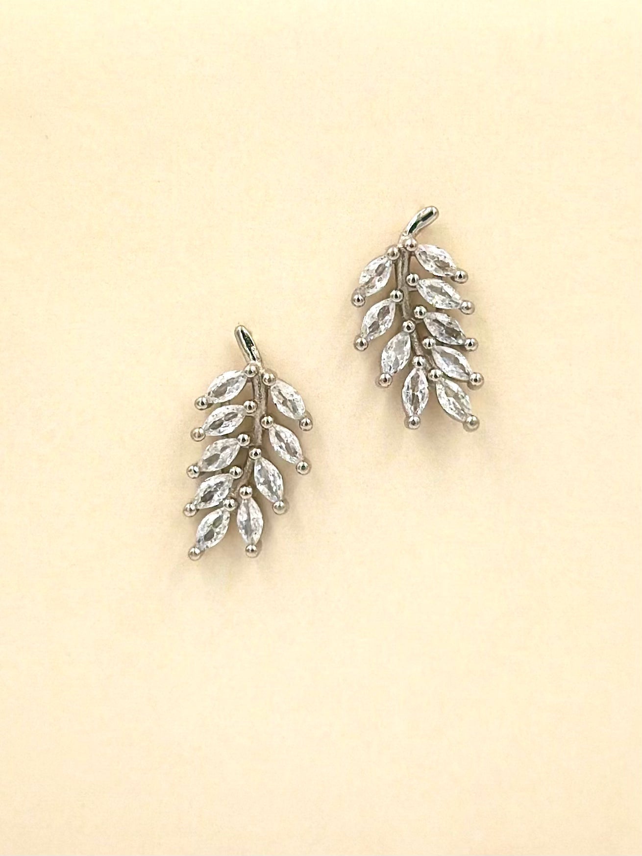 Sterling silver drop earrings in leaf shape, studded with zircon