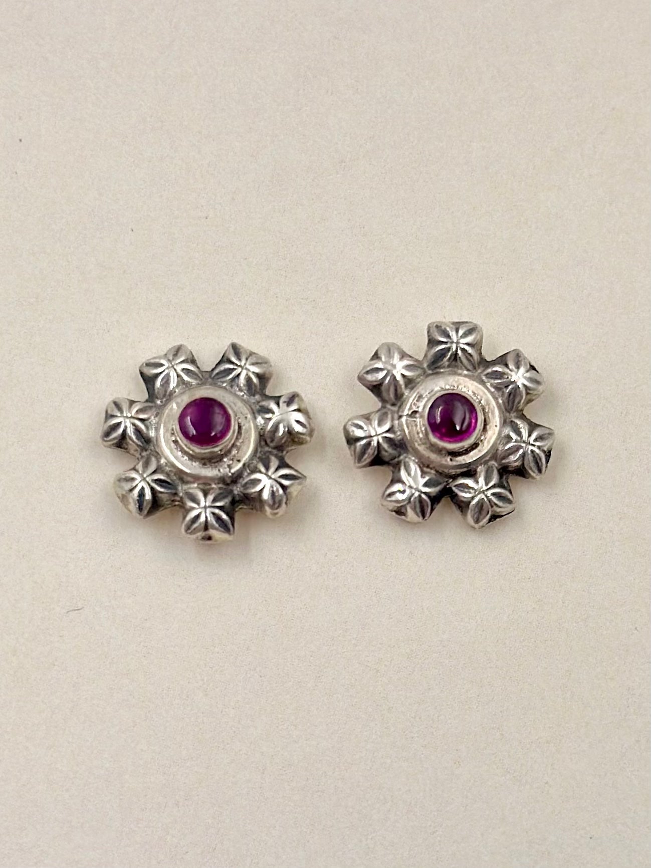Oxidised, flower shaped, studded with ruby, studs in sterling silver