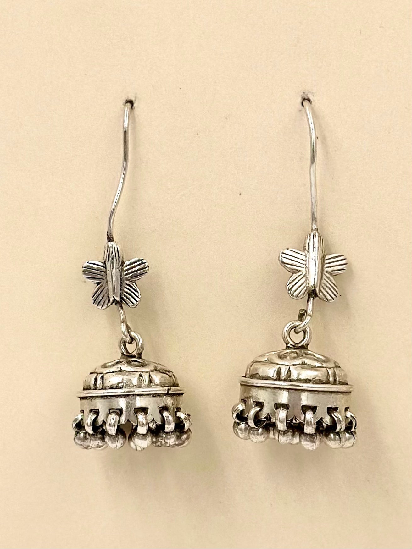 Oxidised, topped with a small butterfly and a detailed mini jhumka, sterling silver drop earrings