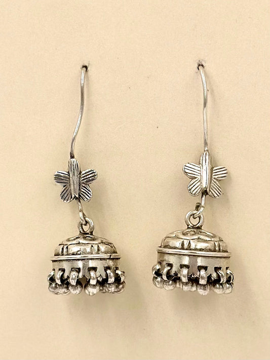 Oxidised, topped with a small butterfly and a detailed mini jhumka, sterling silver drop earrings