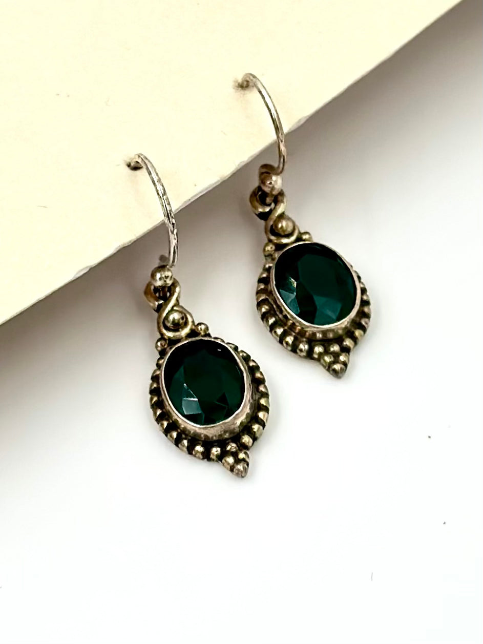 With an emerald centre piece and fine oxidised detailing around, sterling silver drop earrings