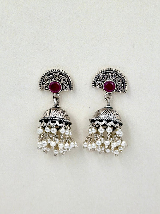 Red stones as center piece, oxidised, pearls studded sterling silver jhumkas
