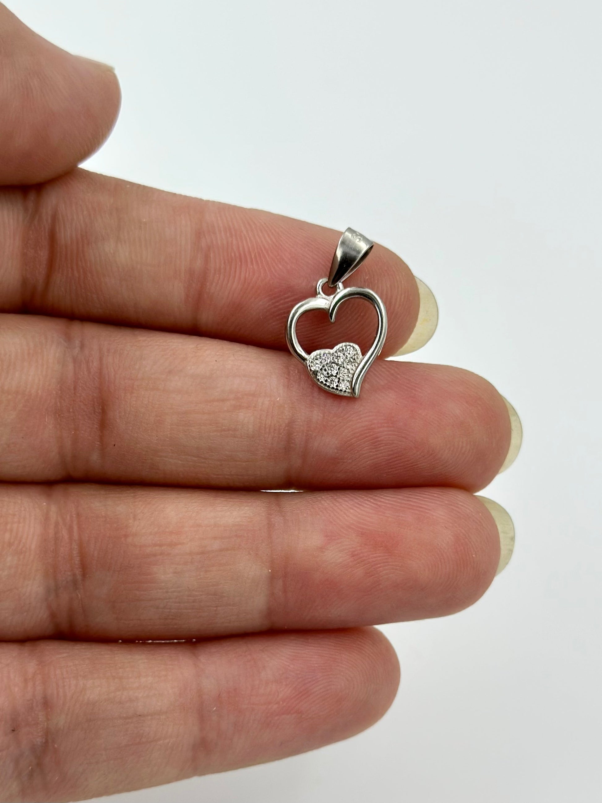Heart shaped, zircon studded sterling silver pendants