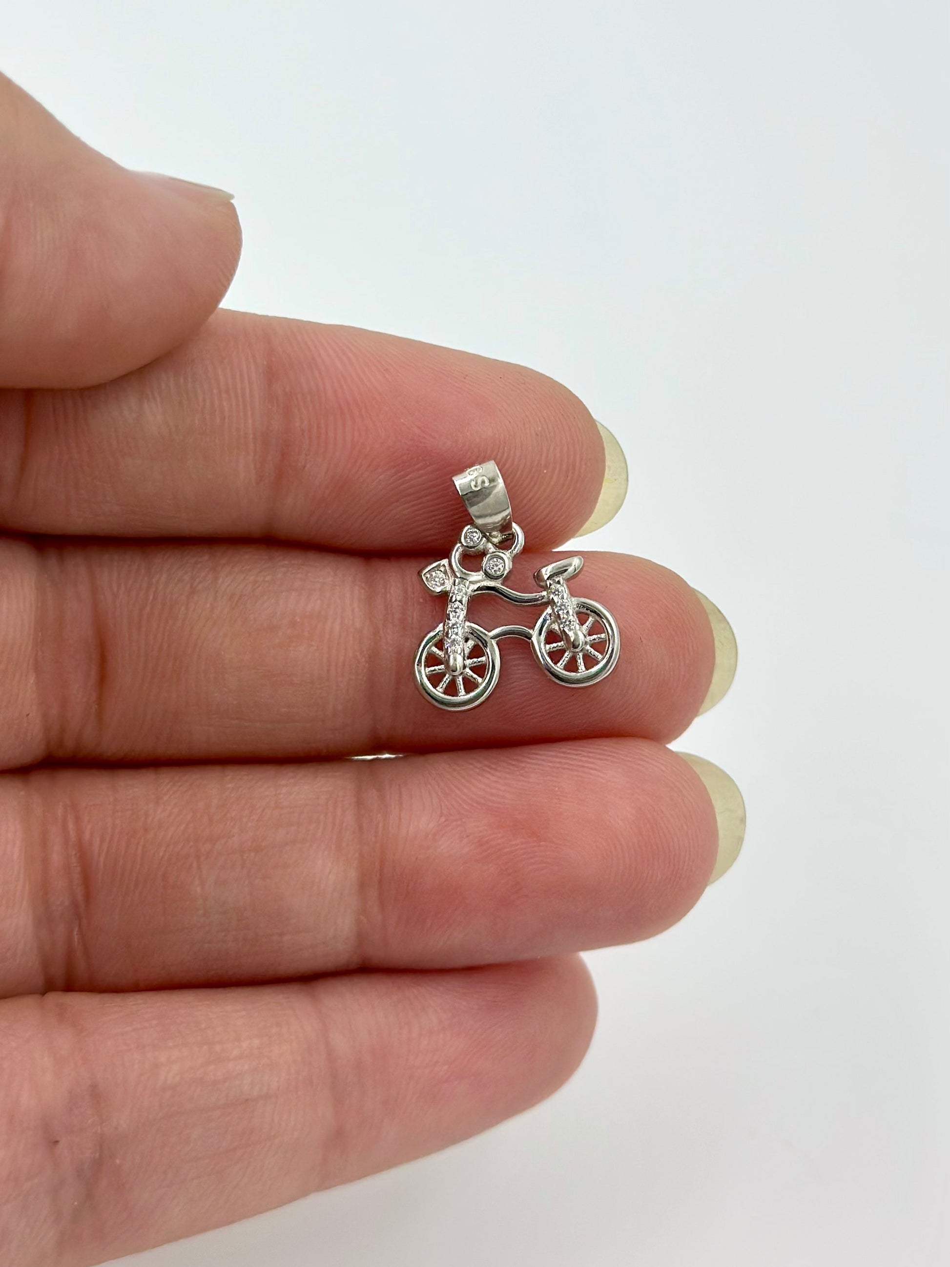 Bicycle shaped, zircon studded sterling silver pendant
