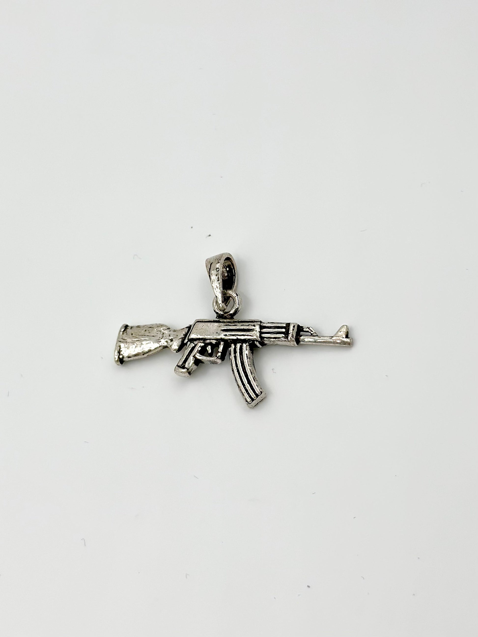 Gun shaped, oxidised sterling silver pendants