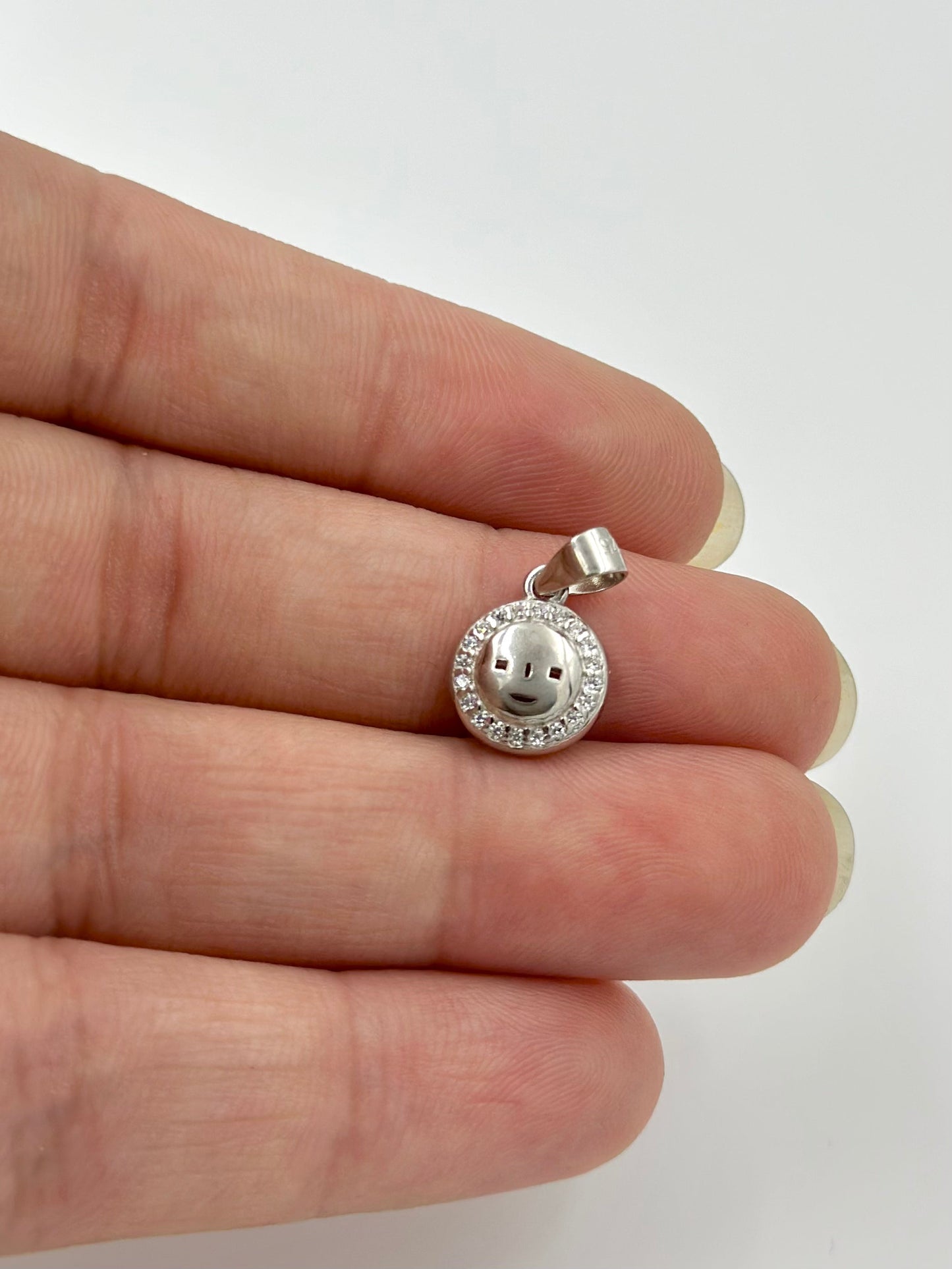 Zircon studdded, face shaped sterling silver pendants