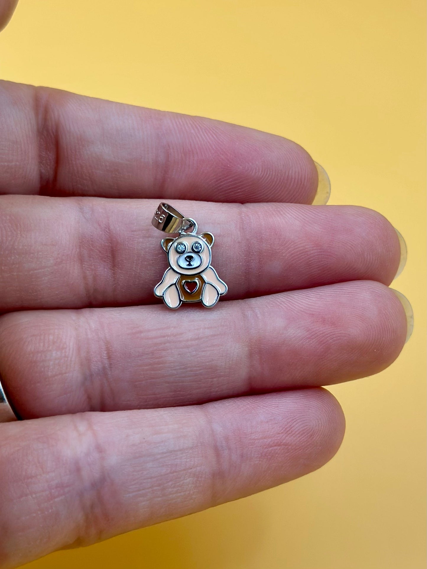 Zircon studded, enamel coated, teddy bear shaped sterling silver pendant