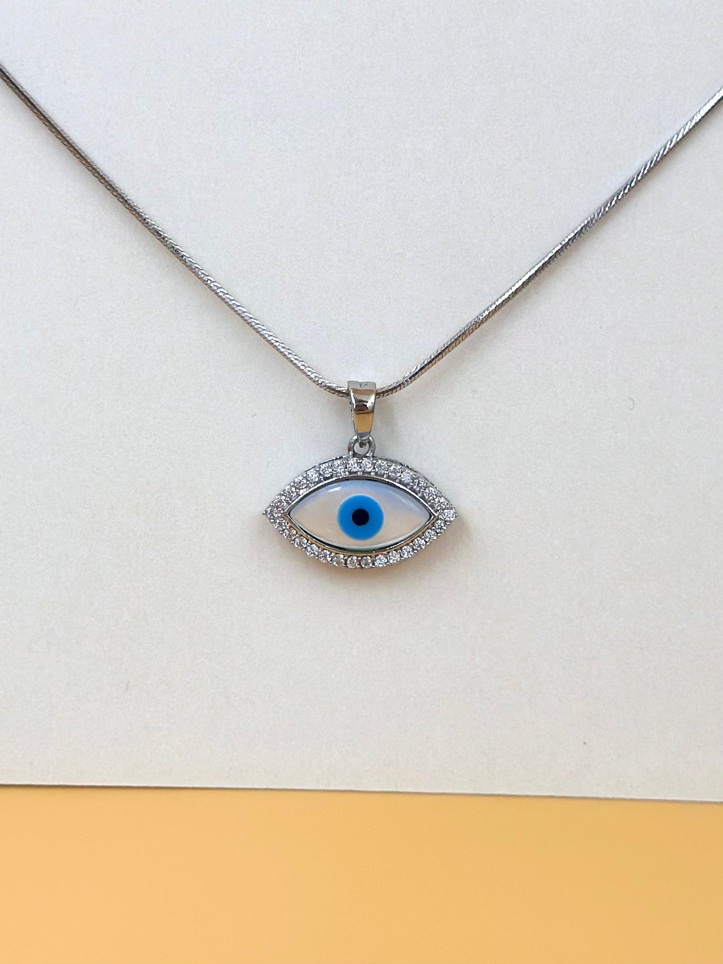 Zircon studded, enamel coated, evil eye sterling silver pendant