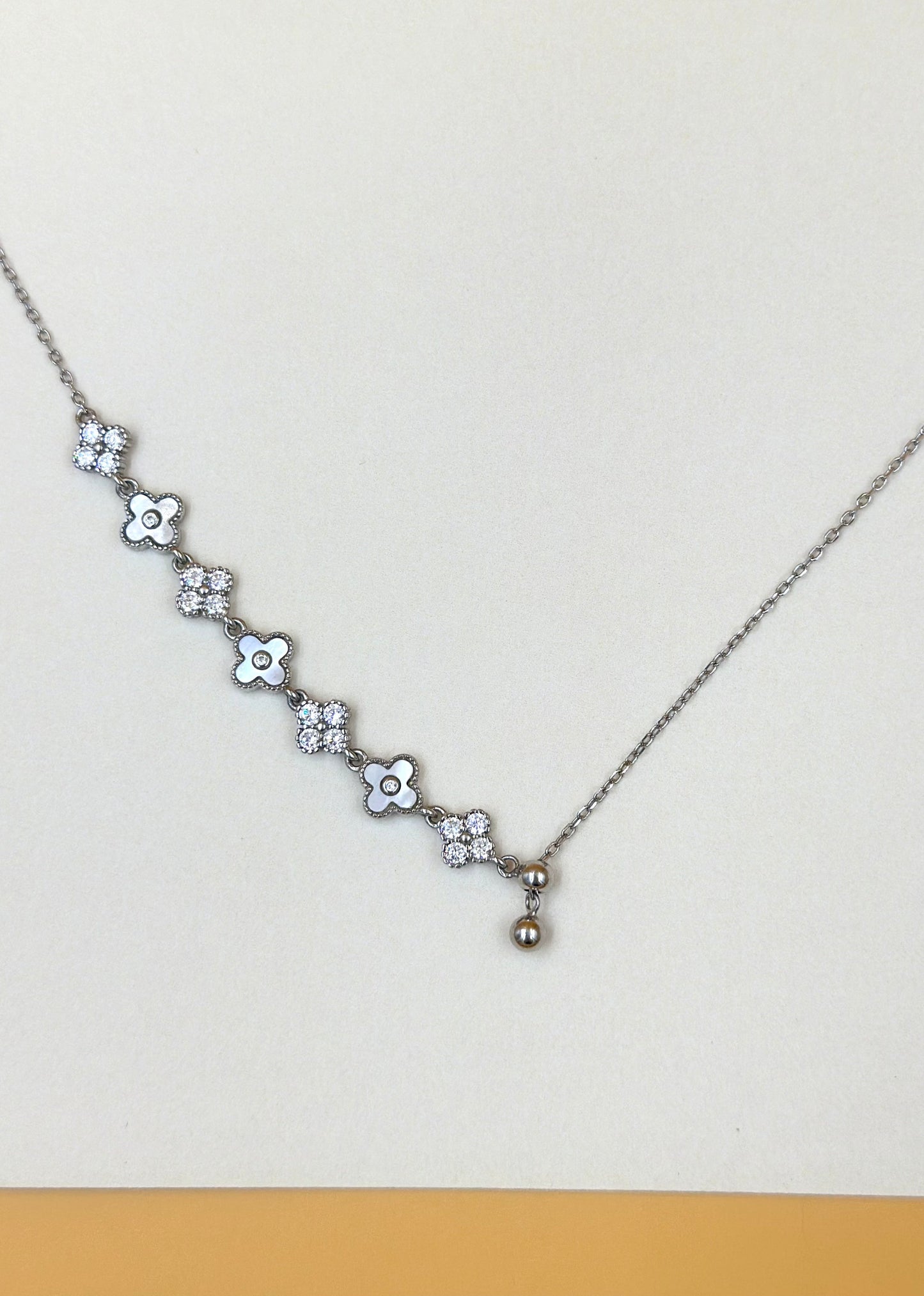 Zircon studded, flower shaped sterling silver pendant chain