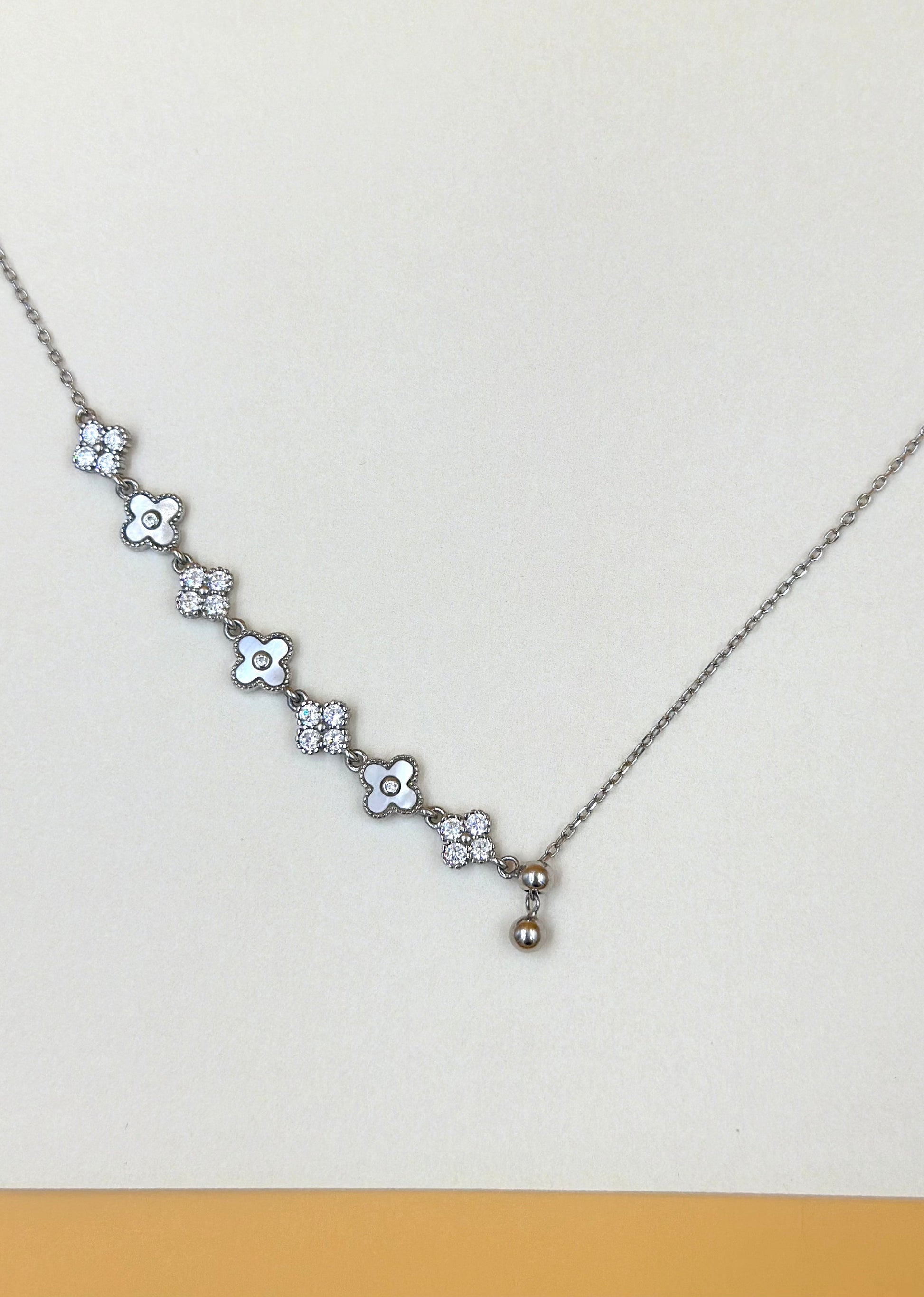 Zircon studded, flower shaped sterling silver pendant chain