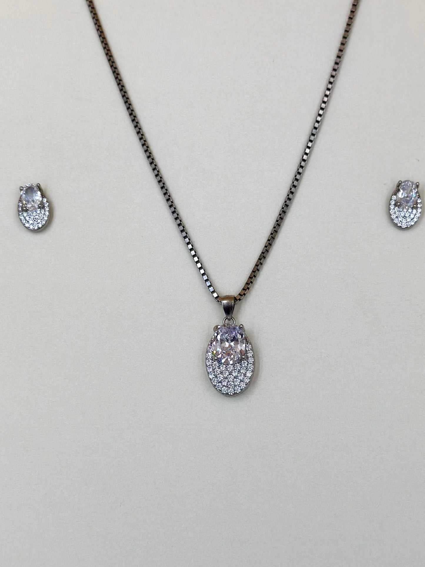 Oval shaped, zircon studded sterling silver pendant set