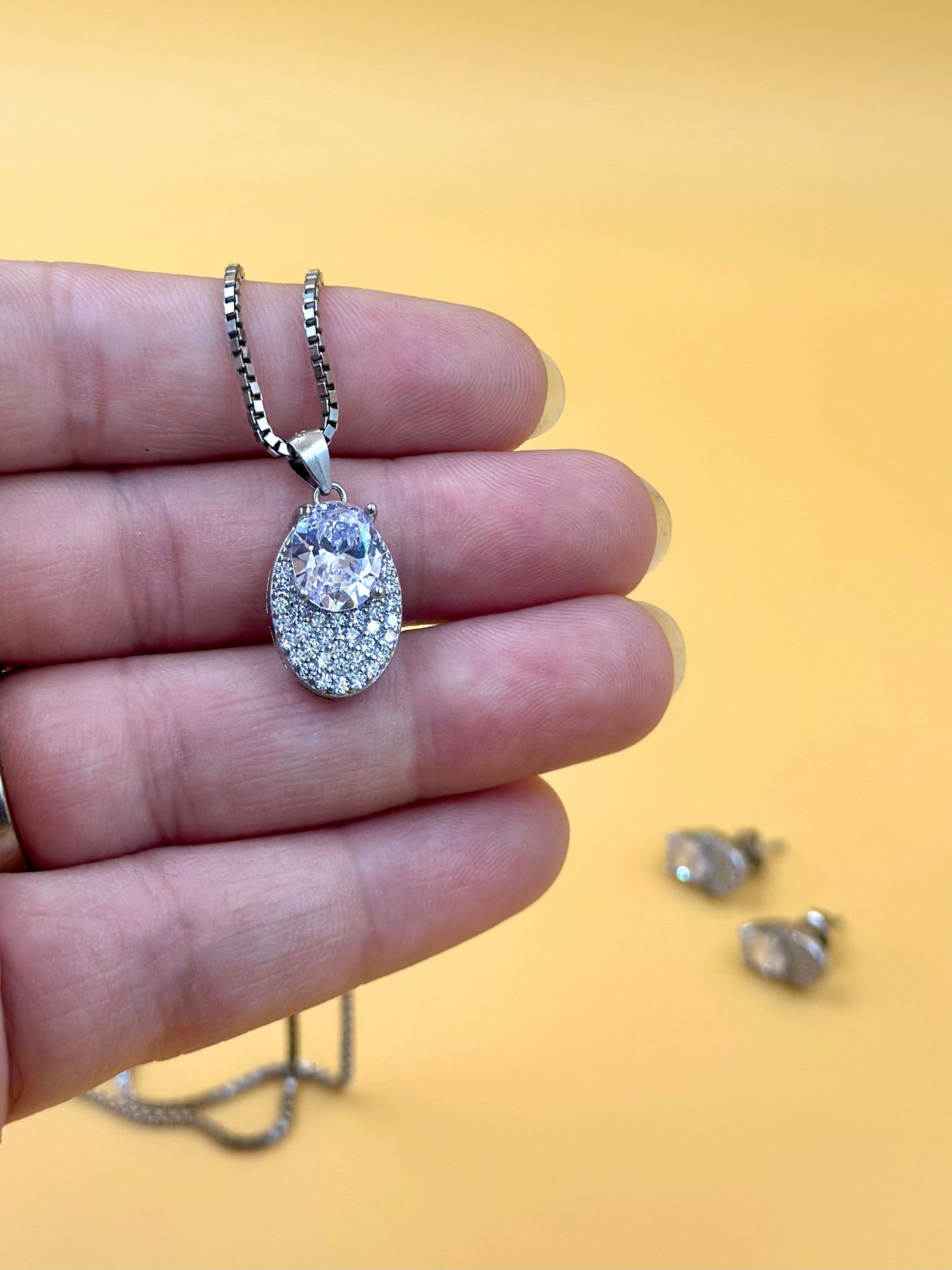 Oval shaped, zircon studded sterling silver pendant set