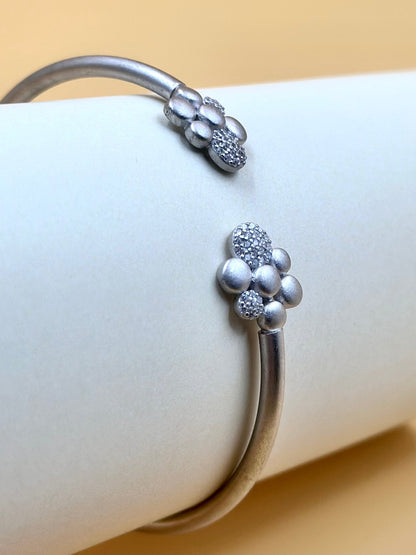 Zircon studded, flower shaped sterling silver cuff bracelet