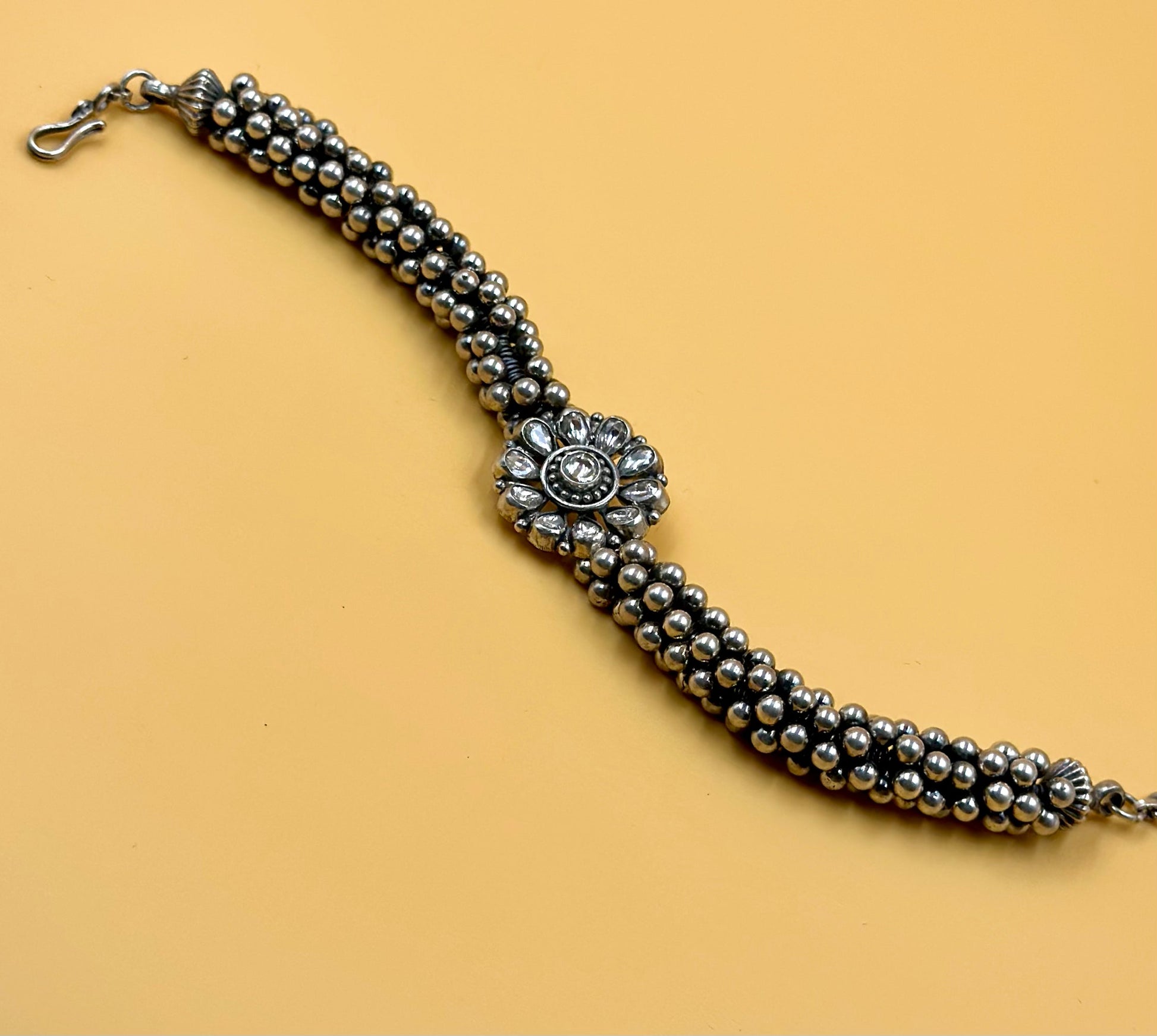 Stone studded, flower shaped sterling silver link bracelet