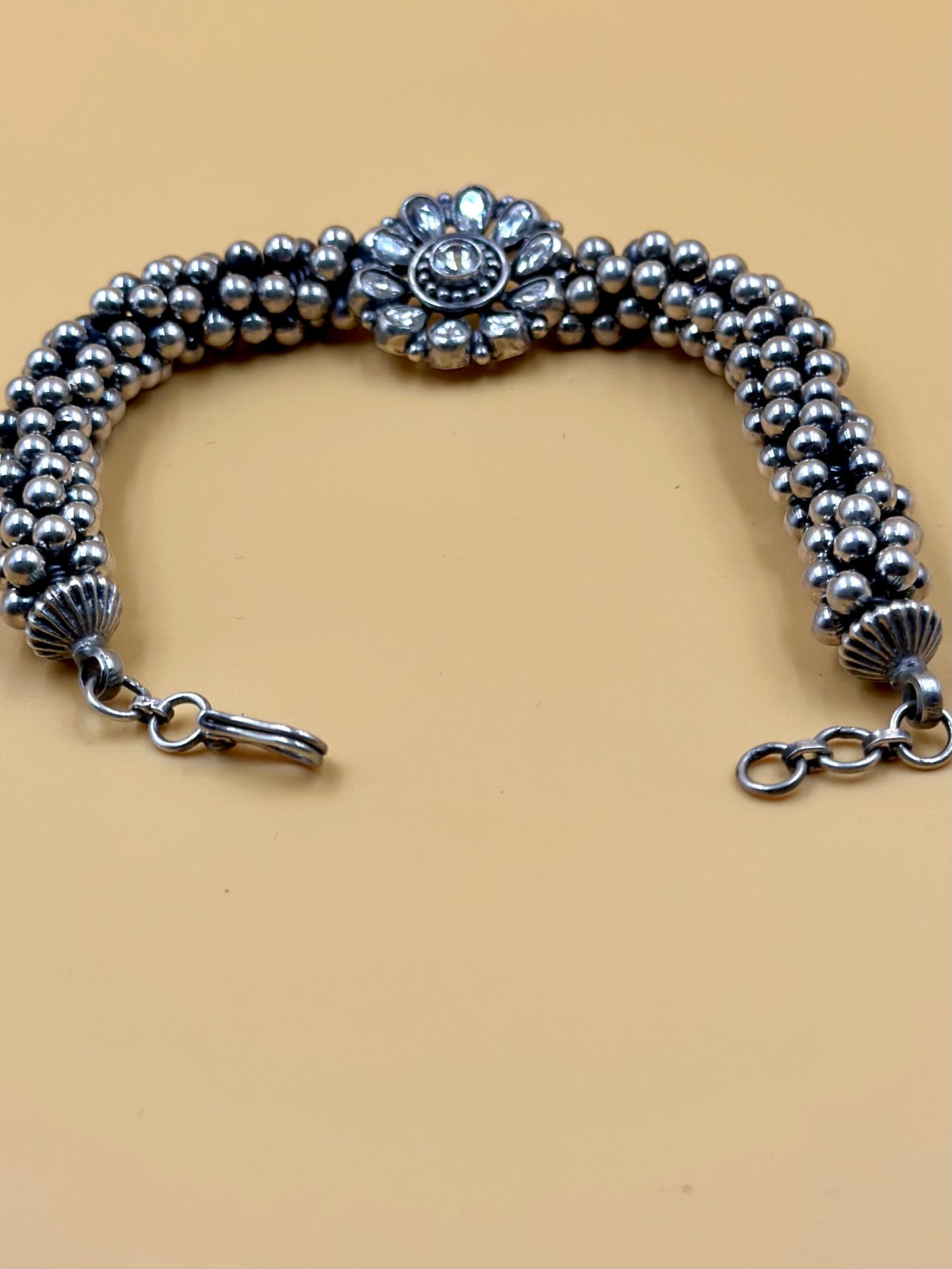 Stone studded, flower shaped sterling silver link bracelet