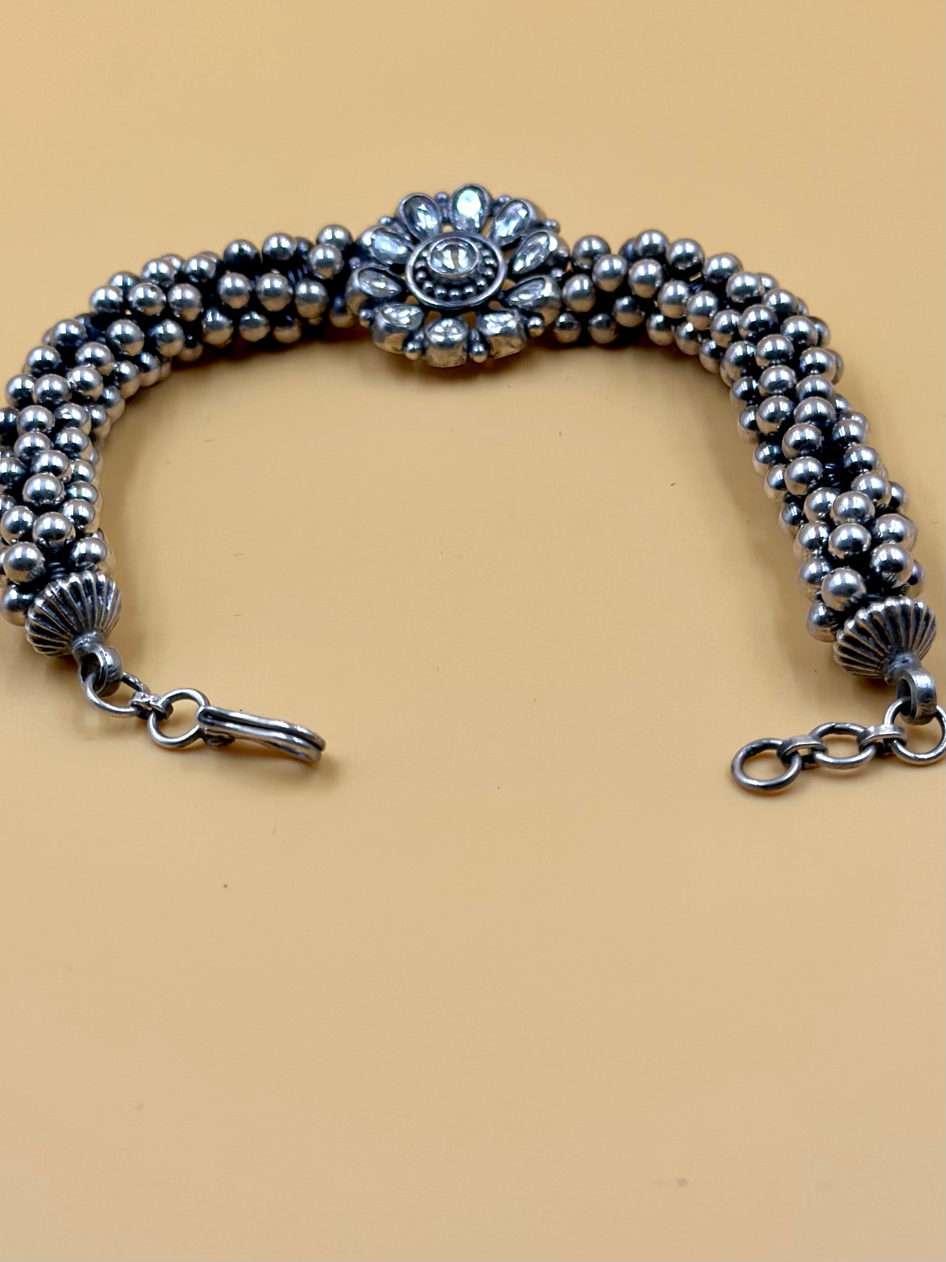 Stone studded, flower shaped sterling silver link bracelet