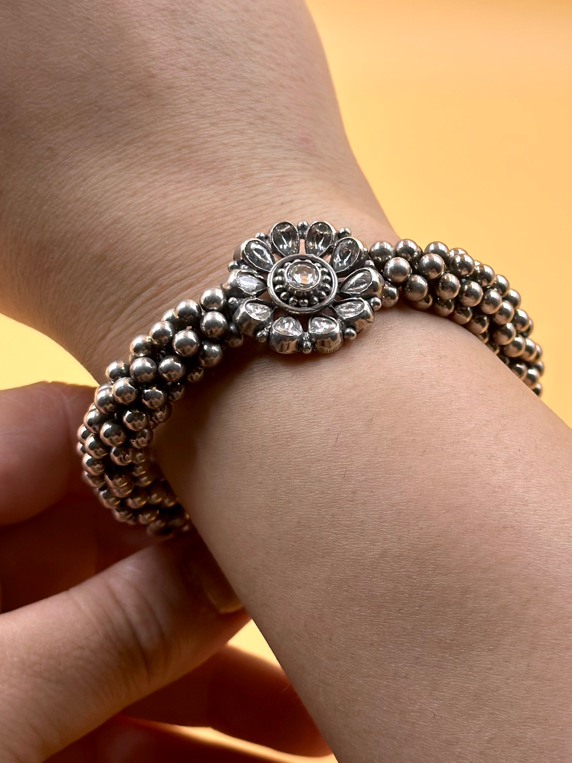 Stone studded, flower shaped sterling silver link bracelet