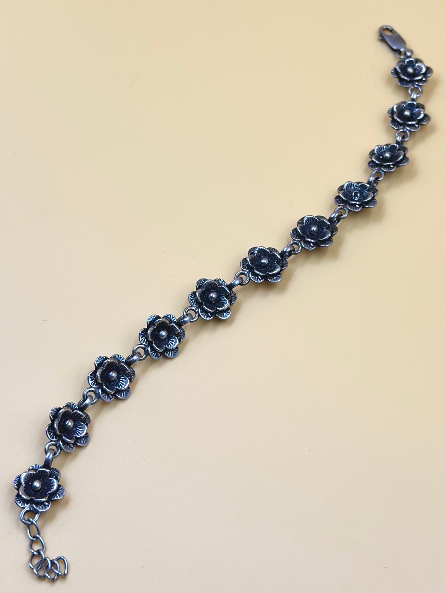 Oxidised, rose shaped sterling silver link bracelet