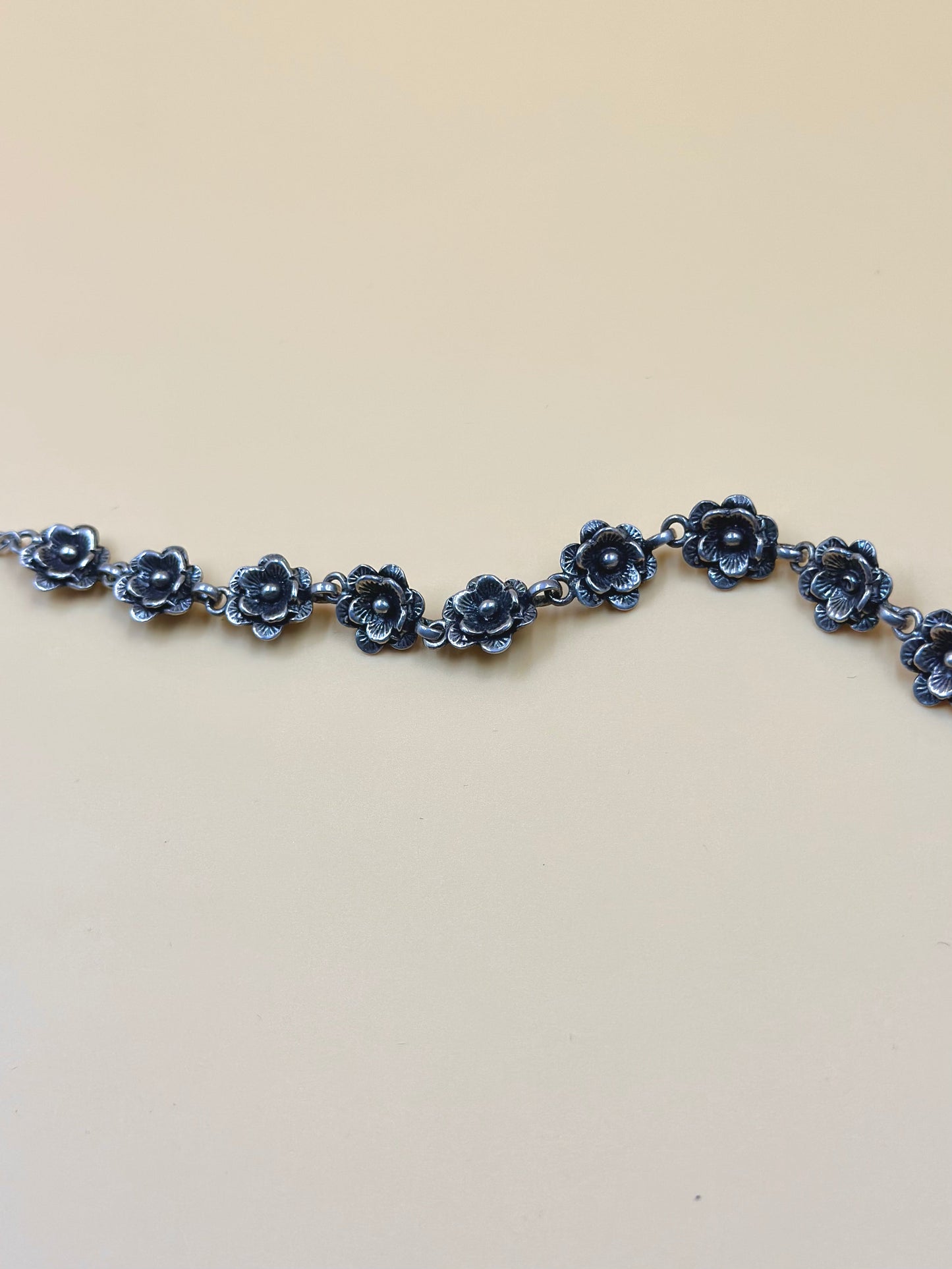 Oxidised, rose shaped sterling silver link bracelet