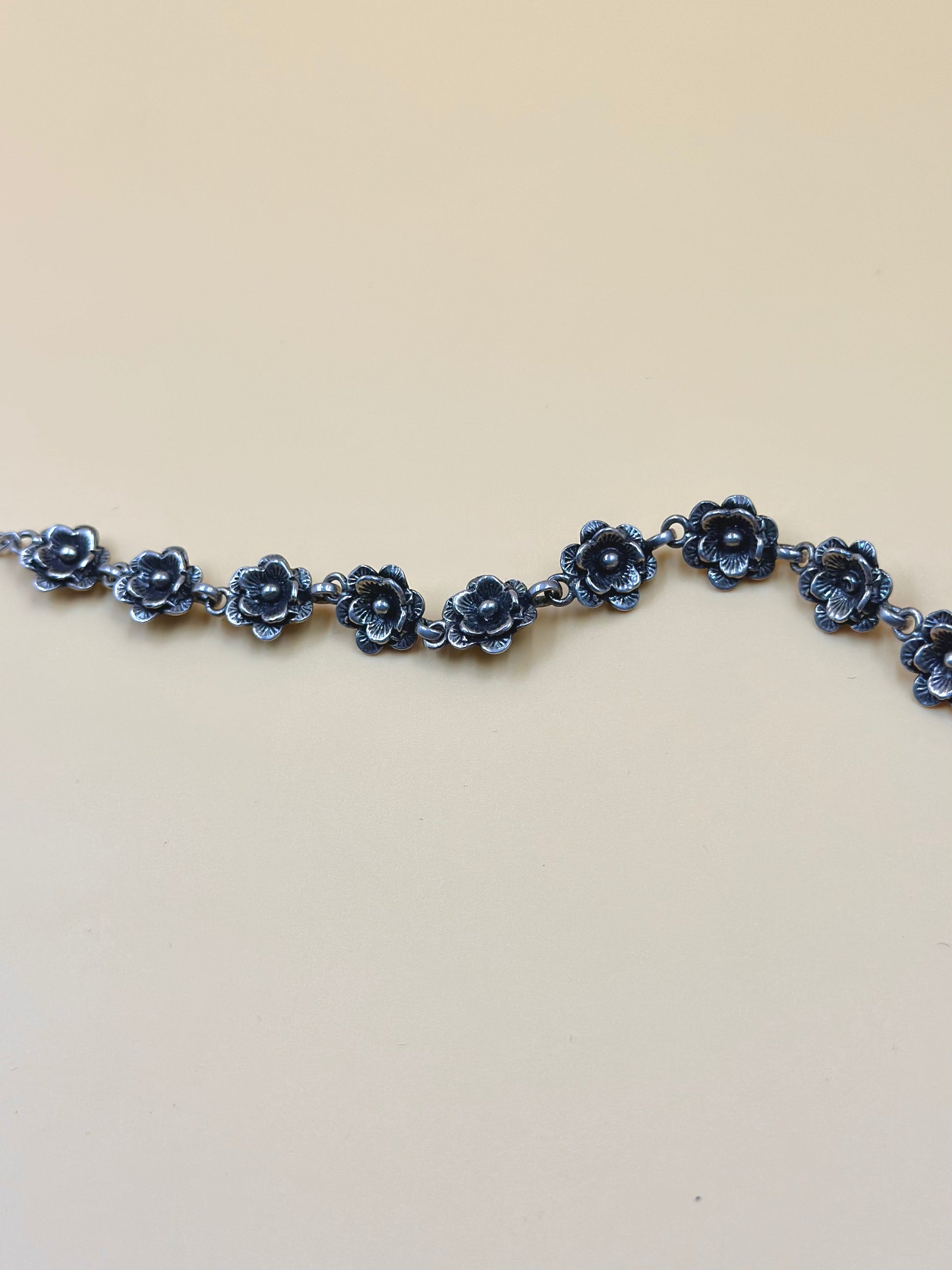 Oxidised, rose shaped sterling silver link bracelet