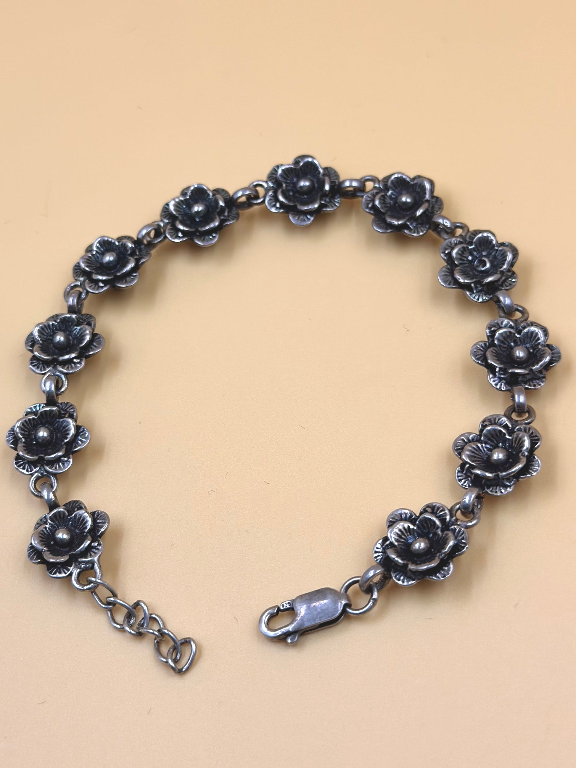 Oxidised, rose shaped sterling silver link bracelet