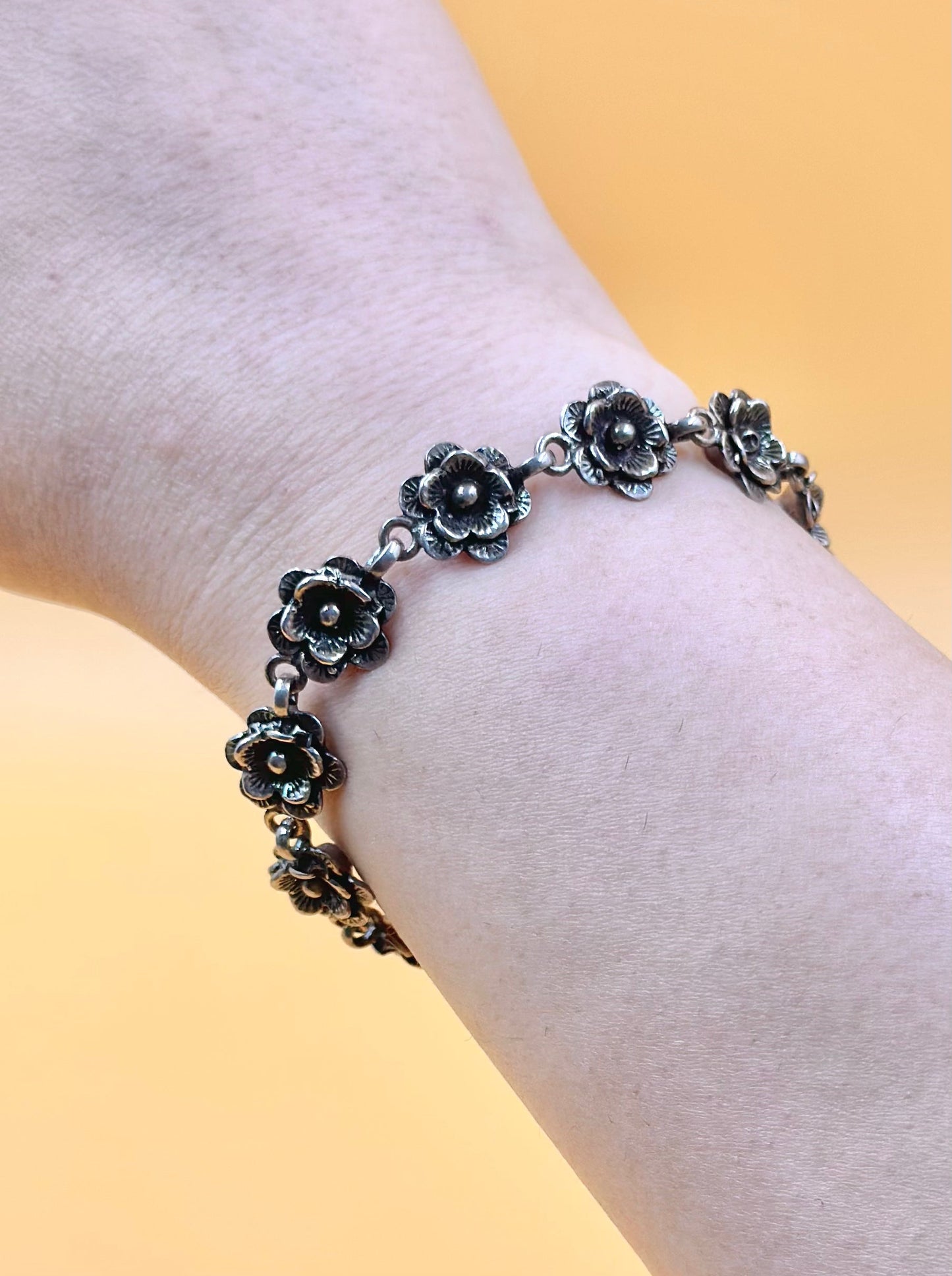 Oxidised, rose shaped sterling silver link bracelet