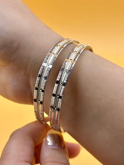 Small rectangular panels and textured pattern sterling silver bangle