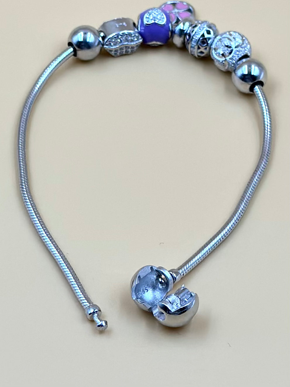 Zircon studded, flower shaped sterling silver charm bracelet