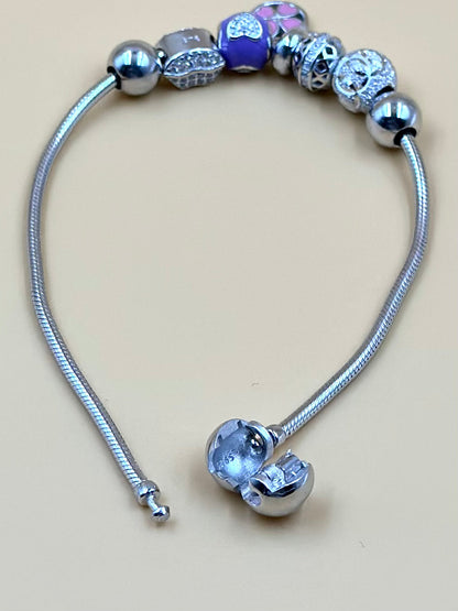 Zircon studded, flower shaped sterling silver charm bracelet