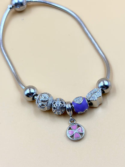 Zircon studded, flower shaped sterling silver charm bracelet