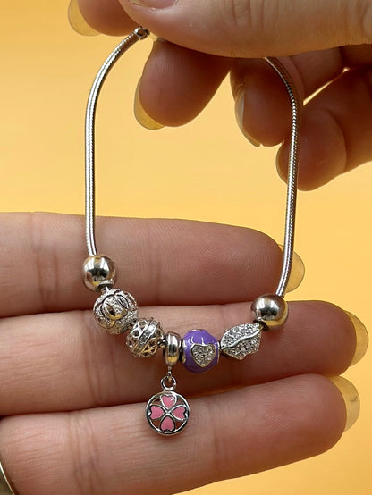 Zircon studded, flower shaped sterling silver charm bracelet