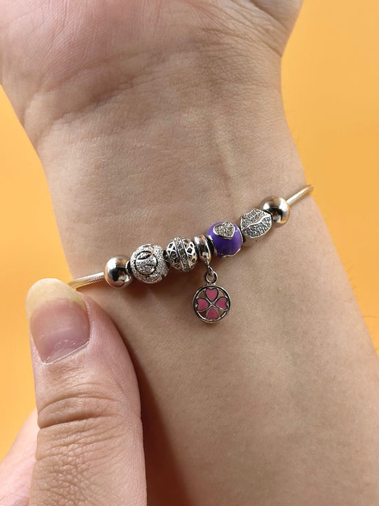 Zircon studded, flower shaped sterling silver charm bracelet