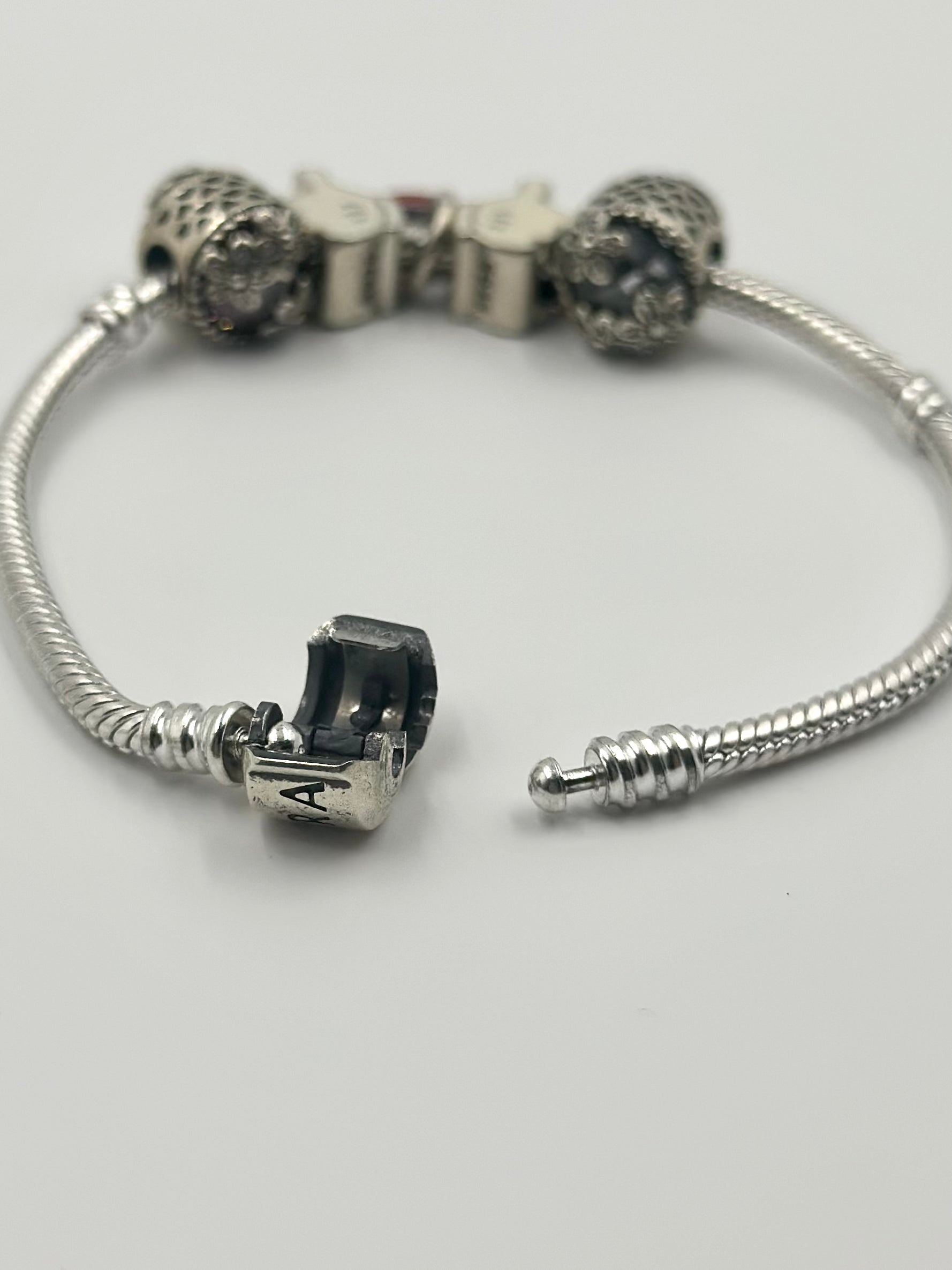 Oxidised, zircon studded, enamel coated sterling silver charm bracelet