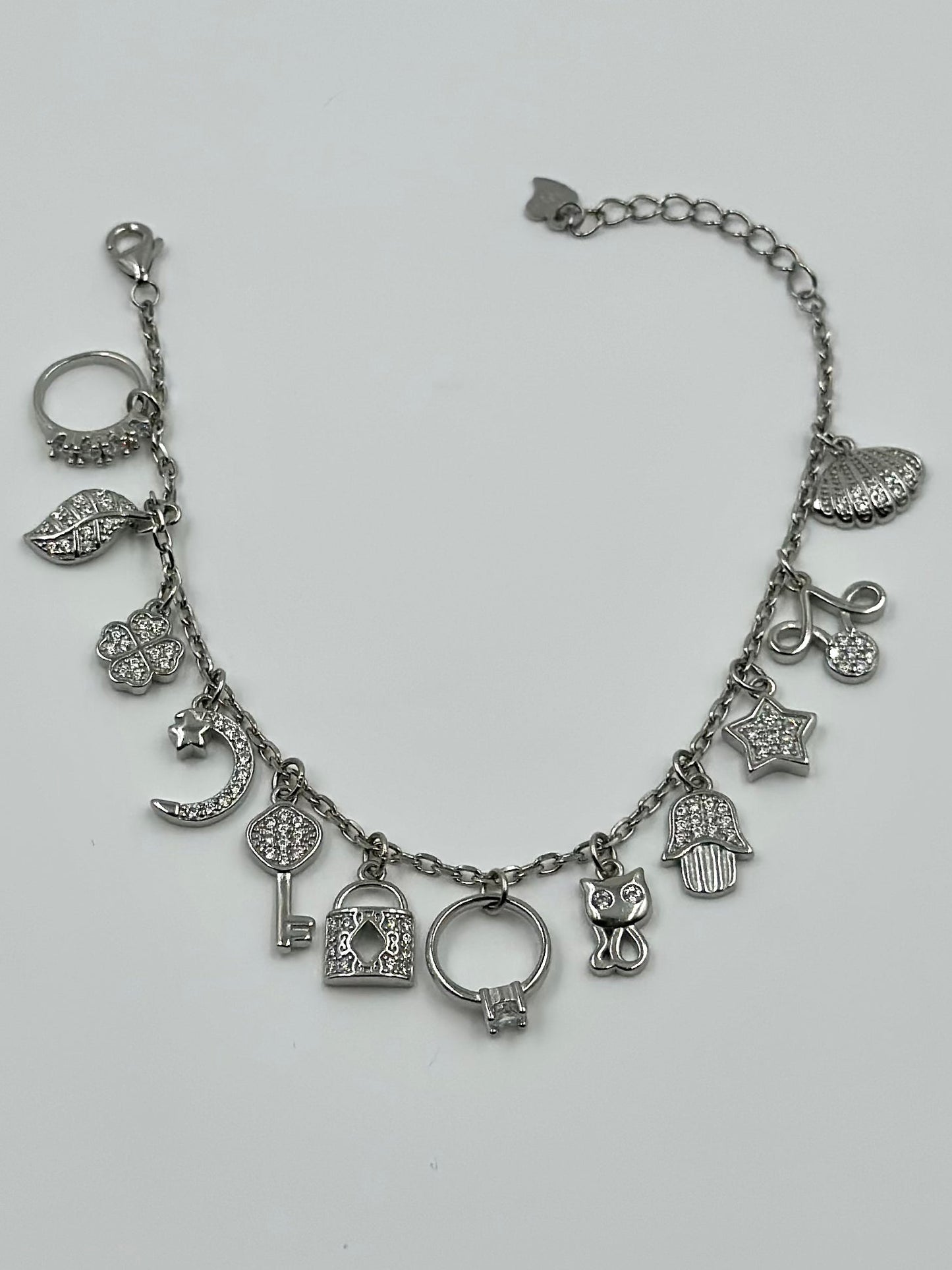 Zircon studded, many shapes charms studded sterling silver charm bracelet