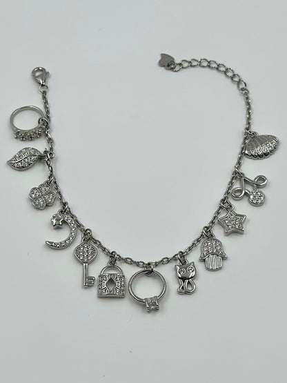 Zircon studded, many shapes charms studded sterling silver charm bracelet