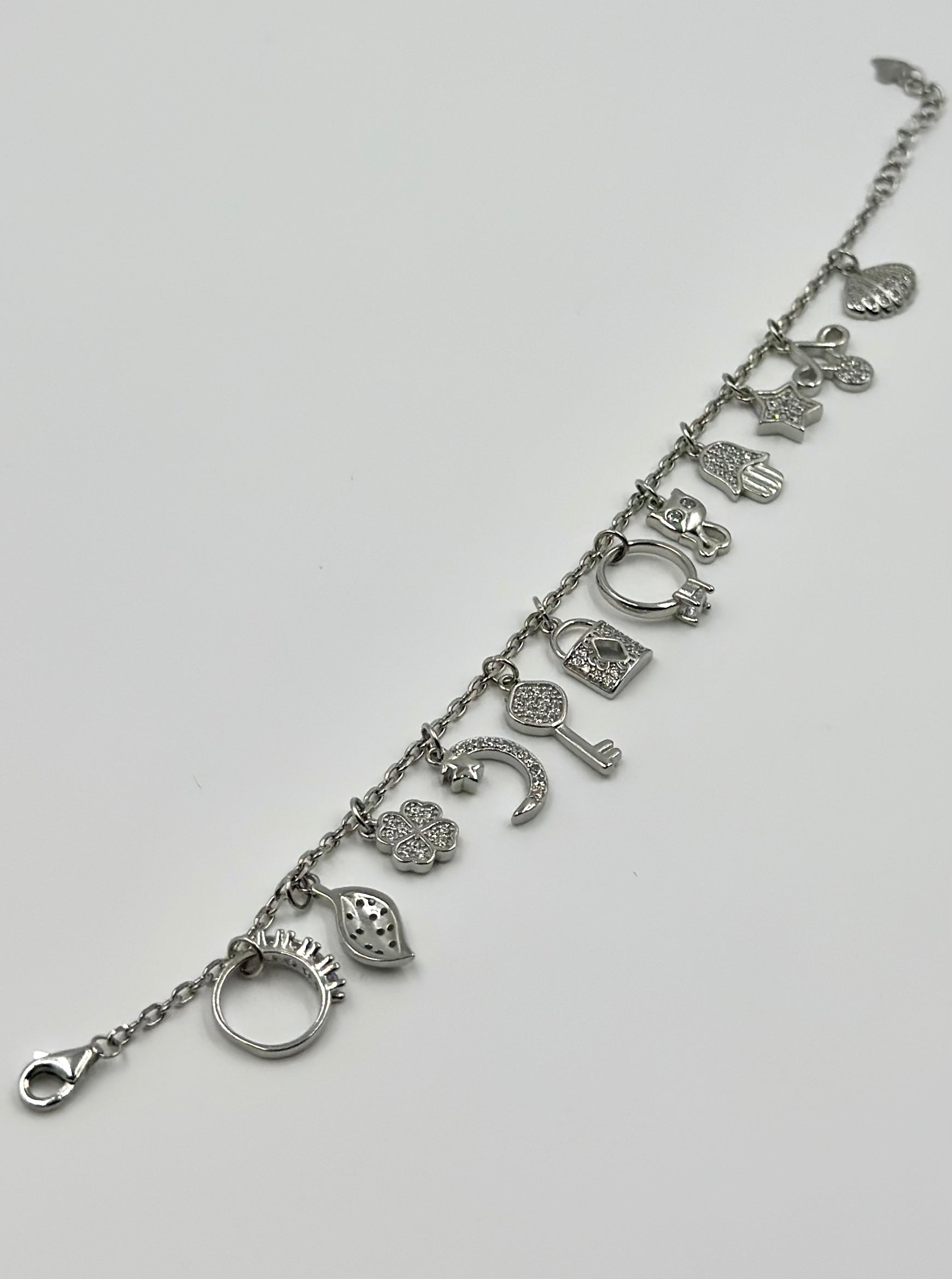 Zircon studded, many shapes charms studded sterling silver charm bracelet