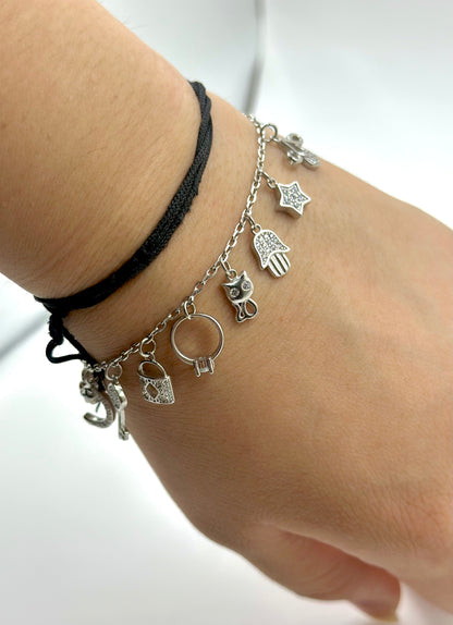 Zircon studded, many shapes charms studded sterling silver charm bracelet